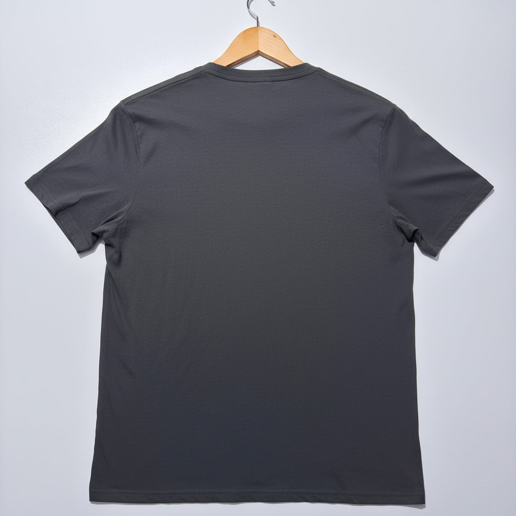 Grey t-shirt on a wooden hanger against a light grey background