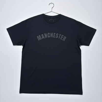 Black t-shirt with 'MANCHESTER' text on a white background