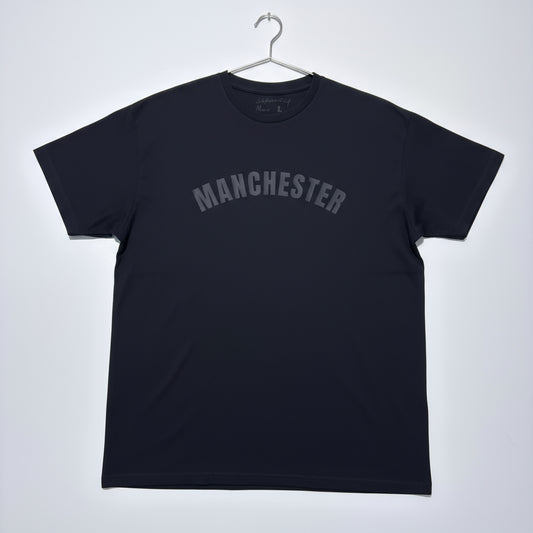 Black t-shirt with 'MANCHESTER' text on a white background