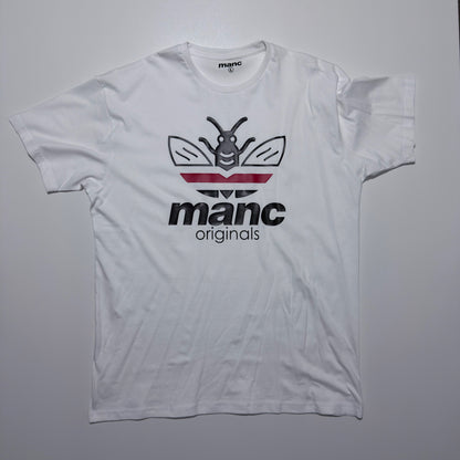 White t-shirt with 'manc originals' logo on a grey background