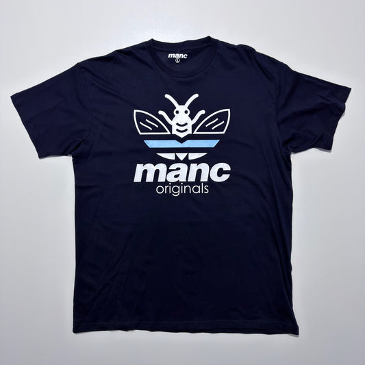 Navy blue t-shirt with 'manc originals' logo on a light grey background