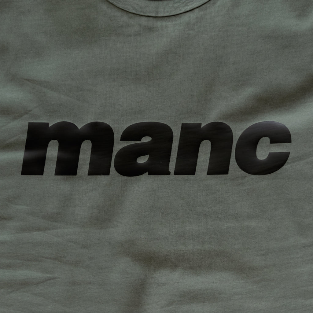 Forest Green t-shirt with 'manc' printed in black 